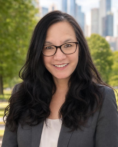 Laura Sequeira, Admissions Advisor, a half-Chinese half-Caucasian woman with long, wavy black hair and a warm, friendly smile.