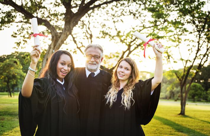 Advisor celebrating with his graduating students