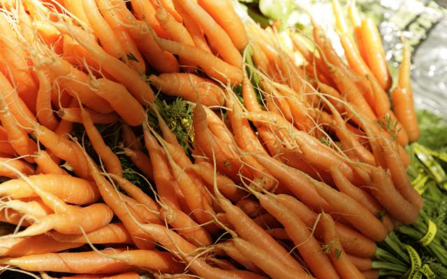 bunches of carrots to be sold at a farmer's market