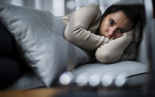 Depressed woman lying down