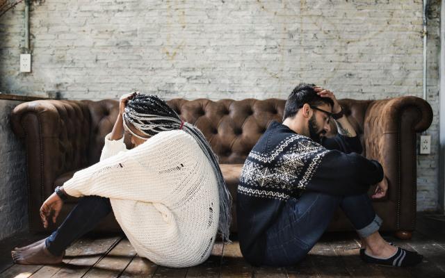 Couple sitting unhappily away from each other