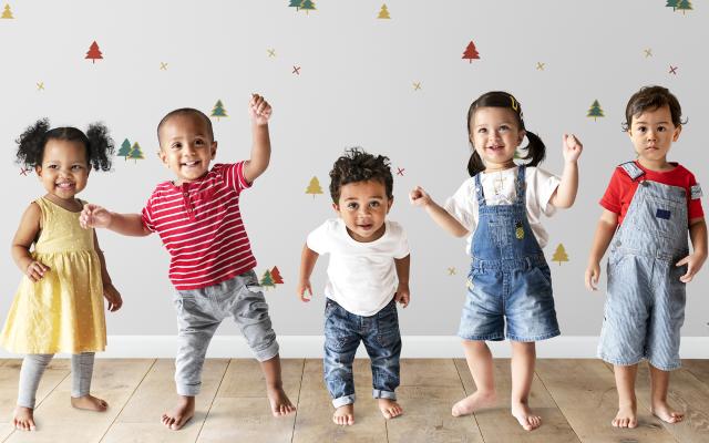several young children in a line jumping up and down