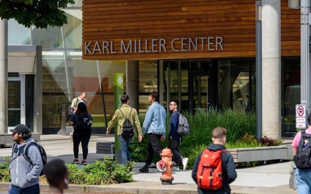 Students walking by the Karl Miller Center.