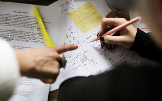 Teacher helping student with physics