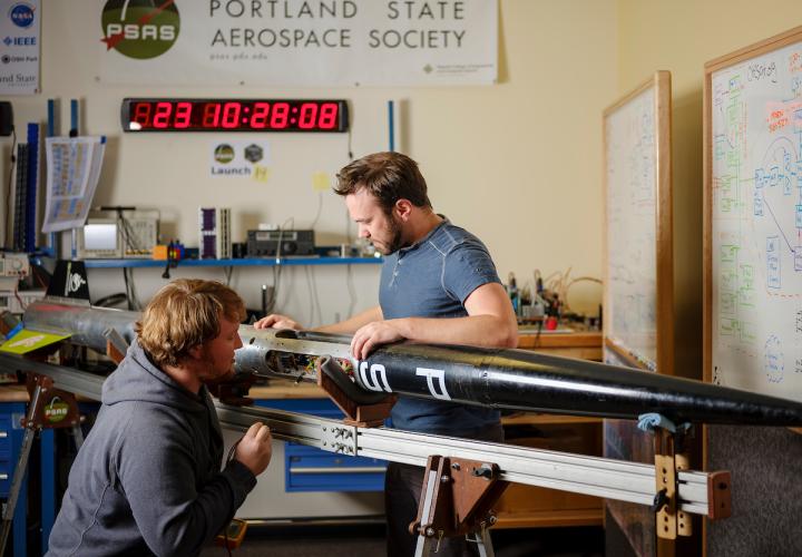 Portland State Aerospace Society students working on a rocket 