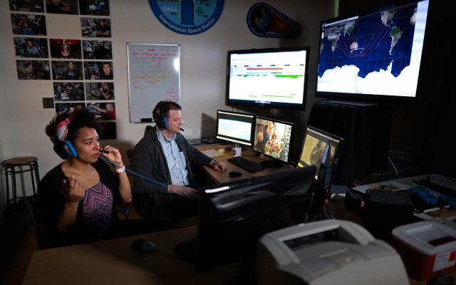 Student and professor connecting with astronauts in Portland State's International Space Station lab