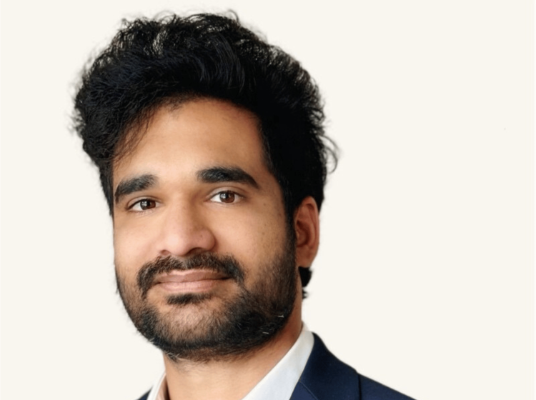 A headshot of a man wearing a suit. 