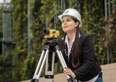 Student with land survey equipment
