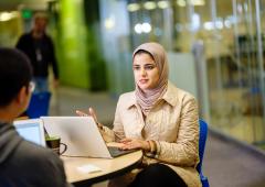 Student using computer to explain concept