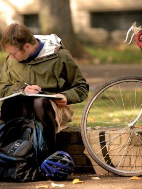 Student studying on bench