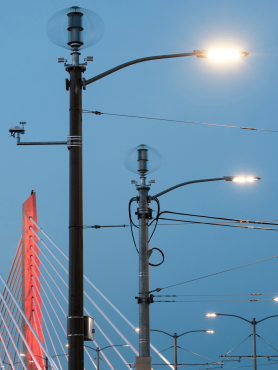 Small wind turbines atop streetlight poles in front of the Tilikum Crossing bridge.