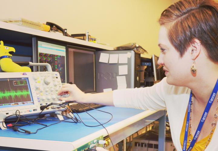 A student turning knobs on a computer