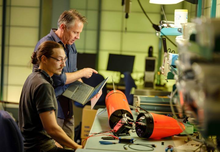 An image of people working with computer