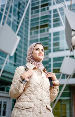 Student standing in front of the engineering building