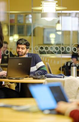 Students looking at laptop