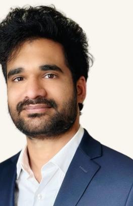 A headshot of a man wearing a suit. 