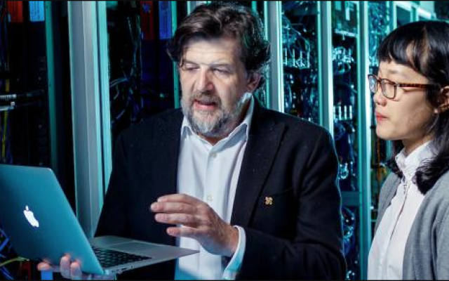 Technical person using a computer to review a server