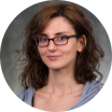 A headshot of a woman wearing glasses.