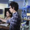 A picture of two people working on a computer.