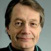 a headshot of Jim Pankow, a white man with brown hair wearing glasses