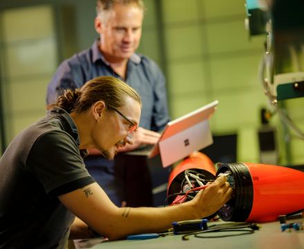 Student and professor working on electrical engineering