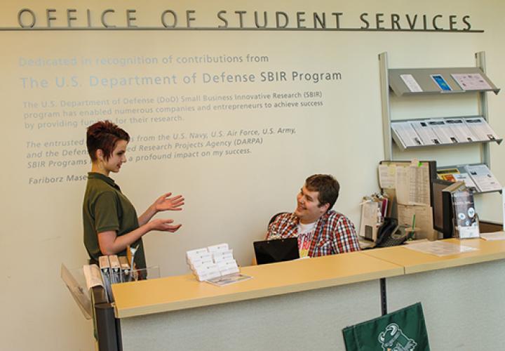 Students chatting in the Office of Student Services