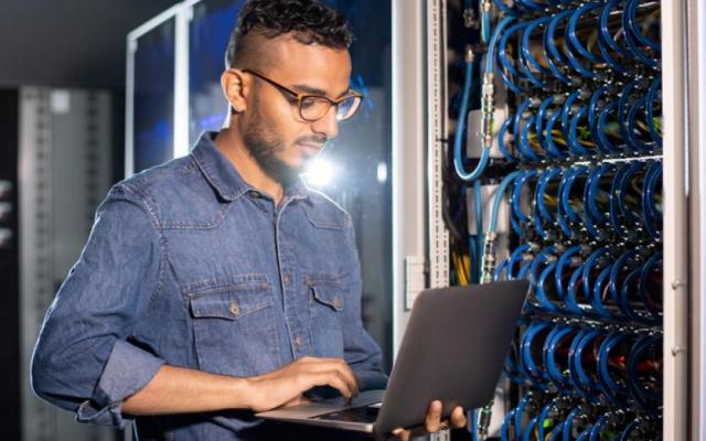 Student on computer in server room