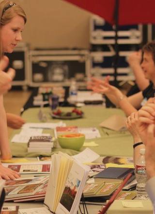 People selling Ooligan books at an event.