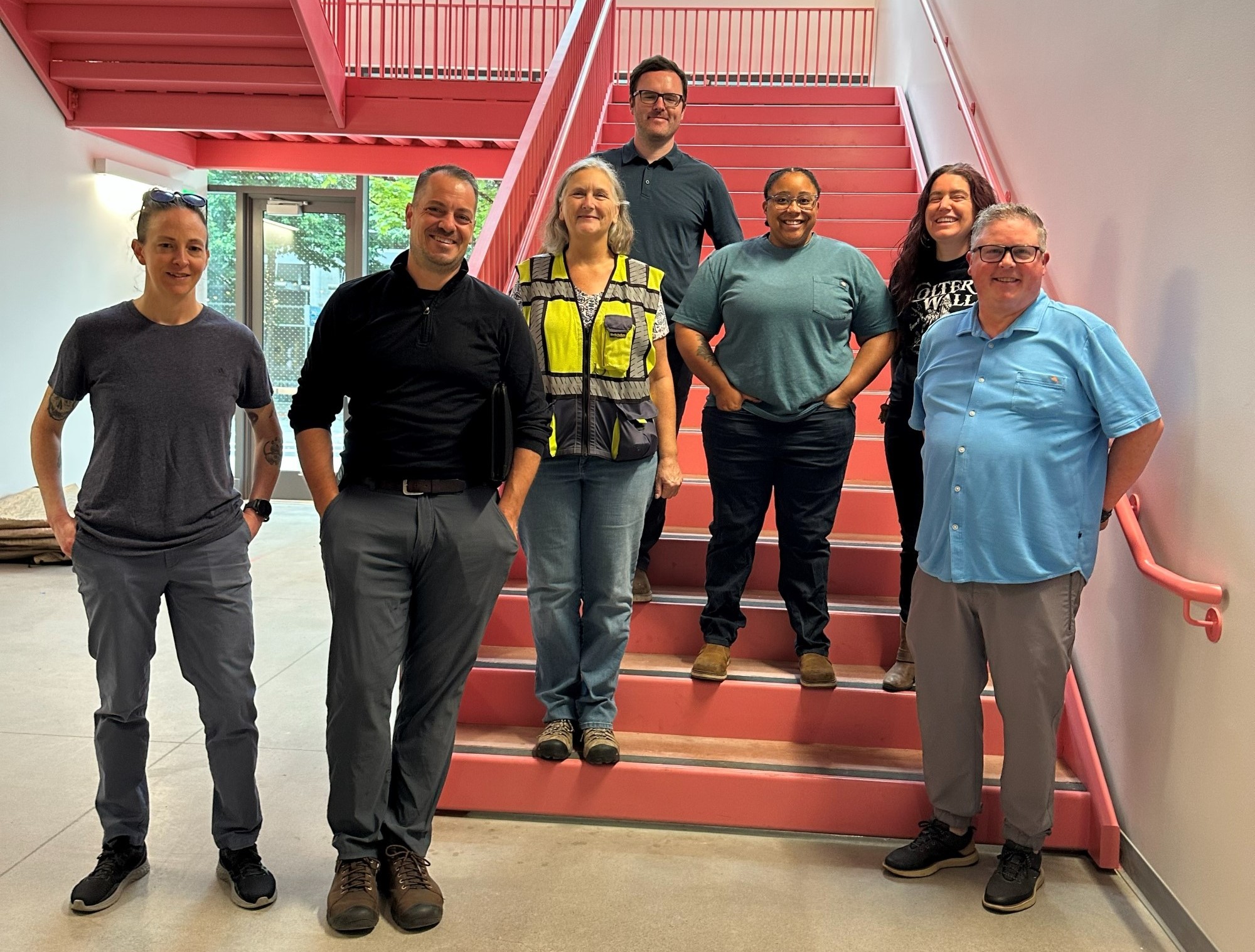 Photo of six people on a staircase.