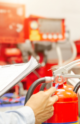 Inspector examining fire extinguishers