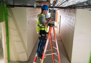 person working with wires on construction site