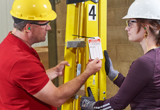 two people inspecting a ladder tag