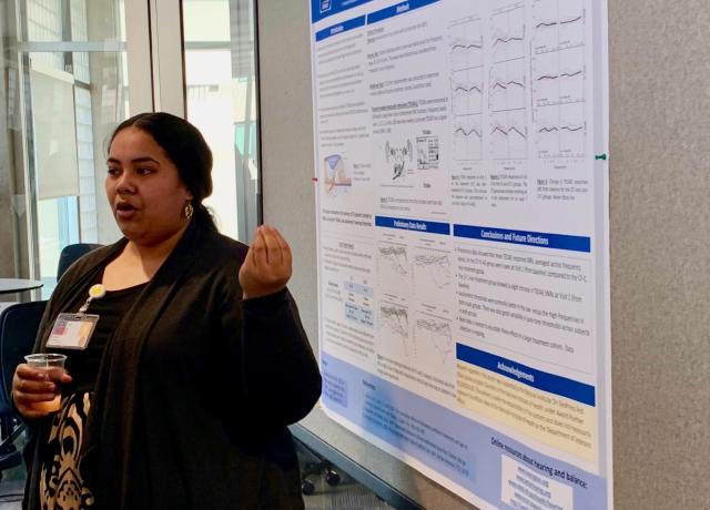 Student stands at a scientific poster