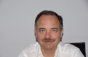 A head shot photo of Scott Wells.