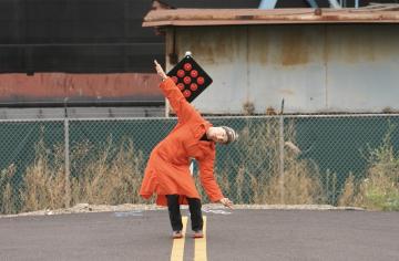 A photo of Linda K Johnson stretching on a paved road.