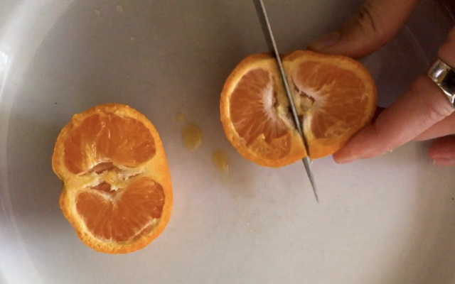 Slicing an orange with a knife