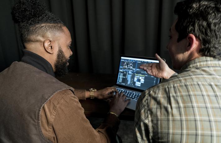 Students with laptop in studio