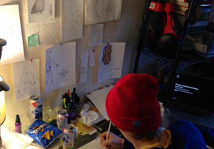 Person in red hat writing