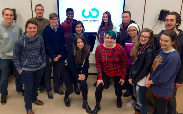 Students posing in front of screen