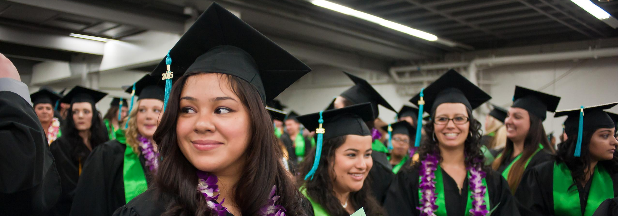 Student in cap and gown for graduation ceremony.