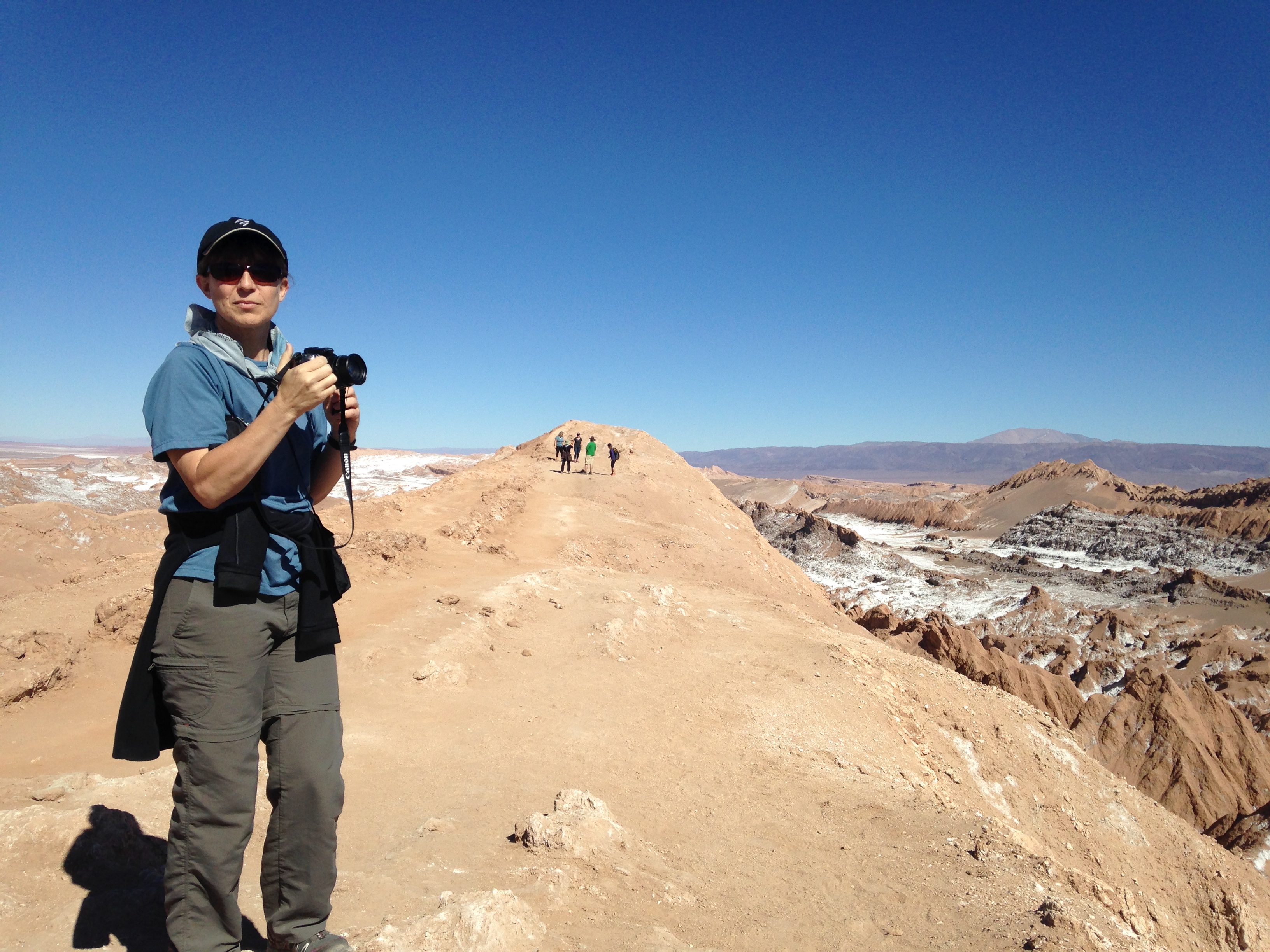 Woman with a camera and scenic view in background