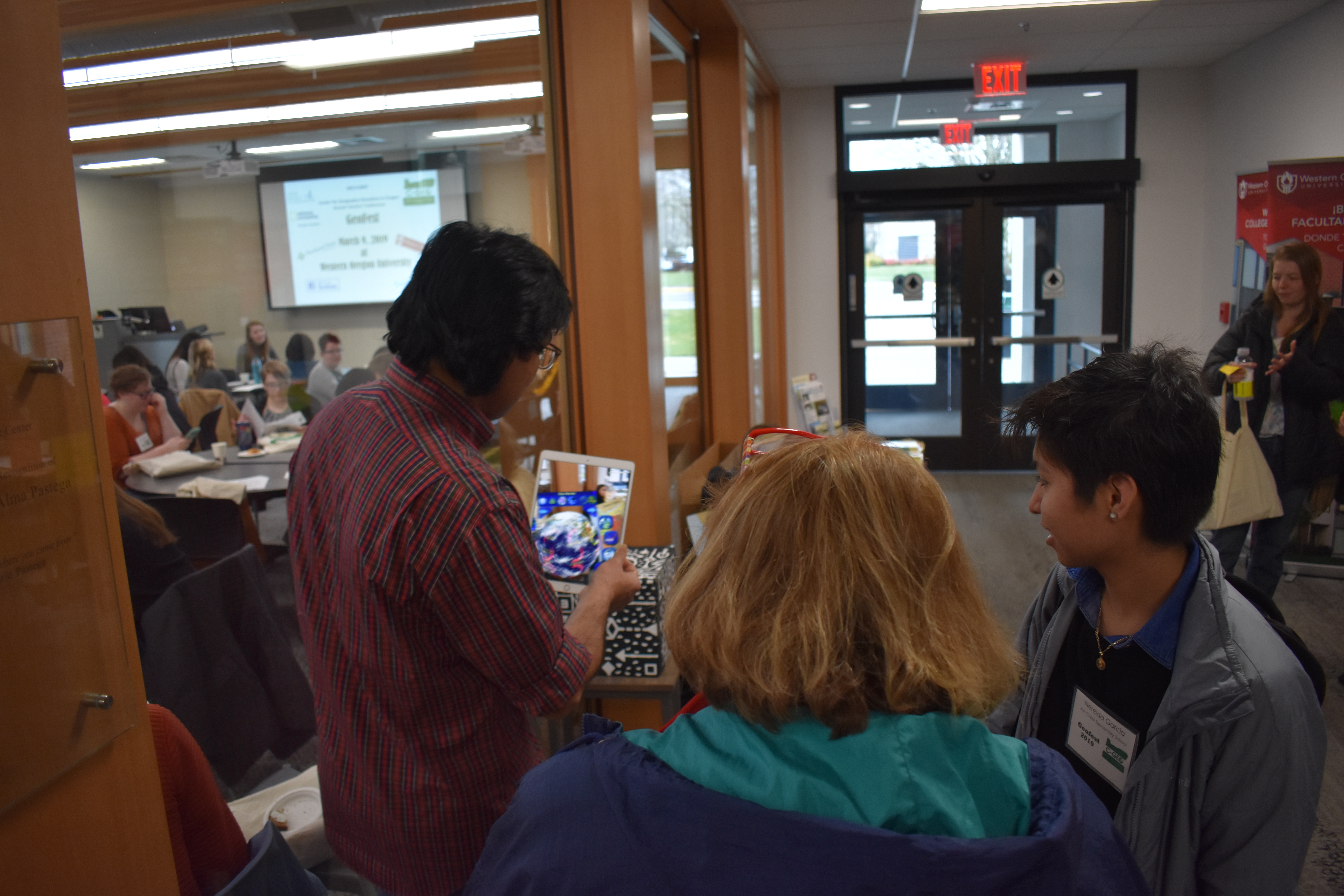 Small group of people viewing an iPad