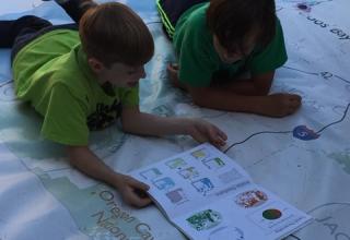 Two boys looking at atlas