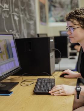 Geography student working on a computer.