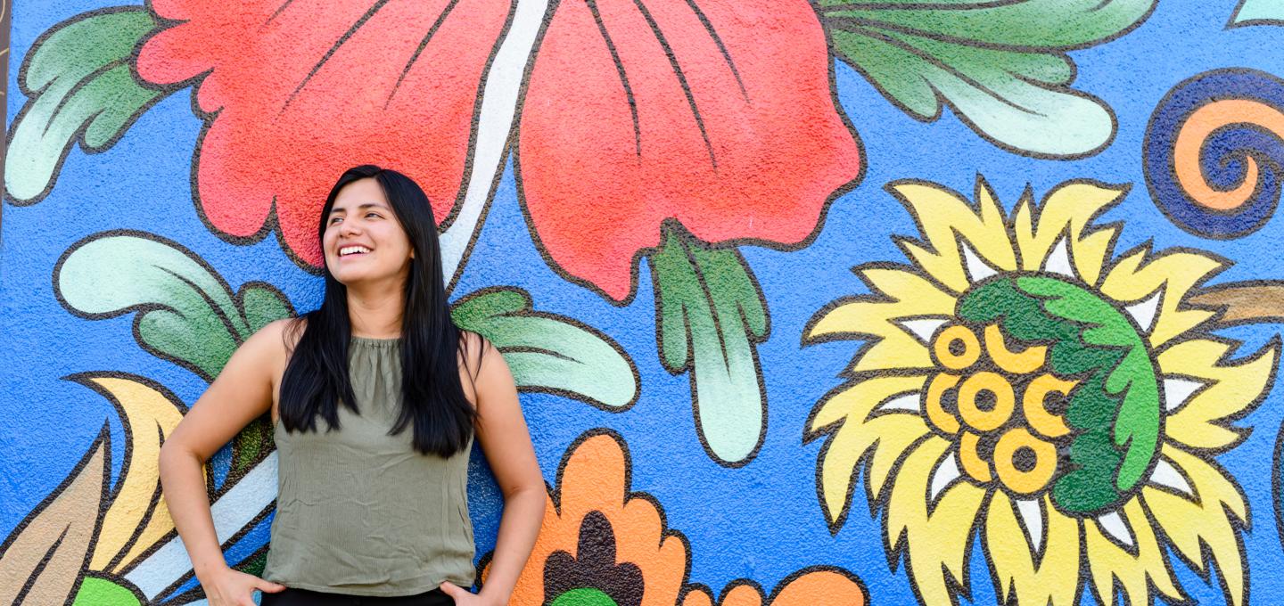 student leaning on wall