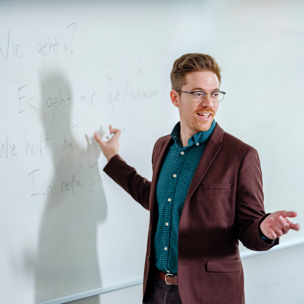 Photo of graduate professor in front of whiteboard