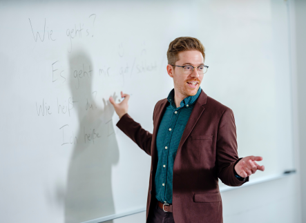 Photo of graduate professor in front of whiteboard
