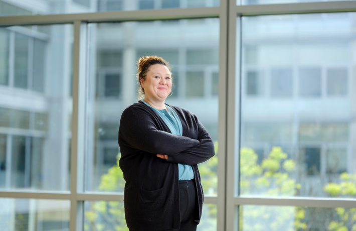 Graduate student with arms crossed