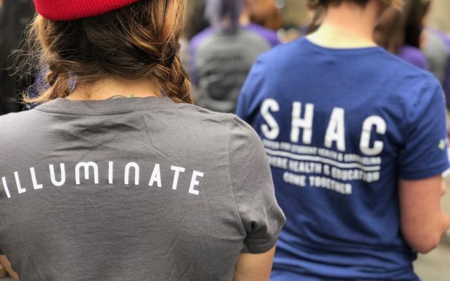 Back of student's shirt that reads "Illuminate".
