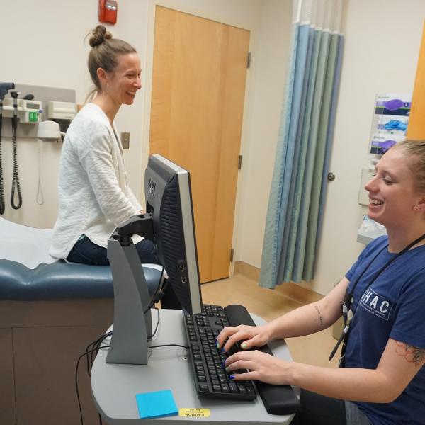 Health Services provider room with a patient sitting on chair.